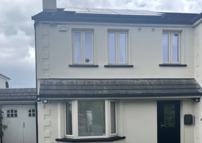 Acrylic render finish with quoin stones and black window sills in Sandymount